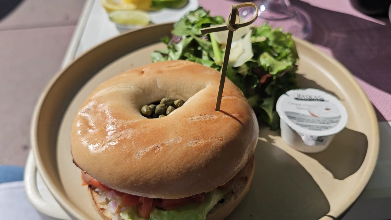 Bagel sandwich with salad on plate